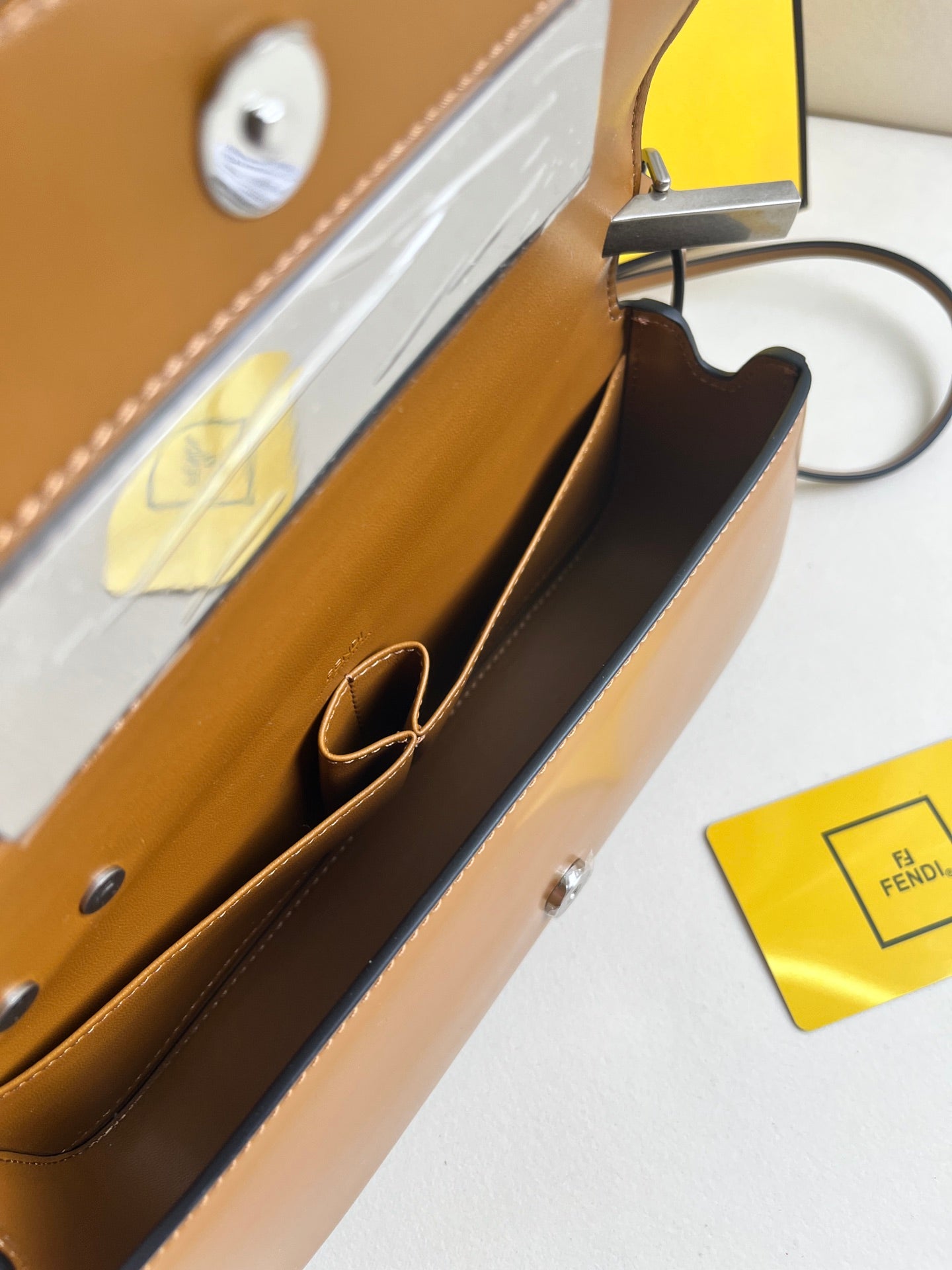 First Sight clutch in smooth calfskin with large F metal hardware and chain