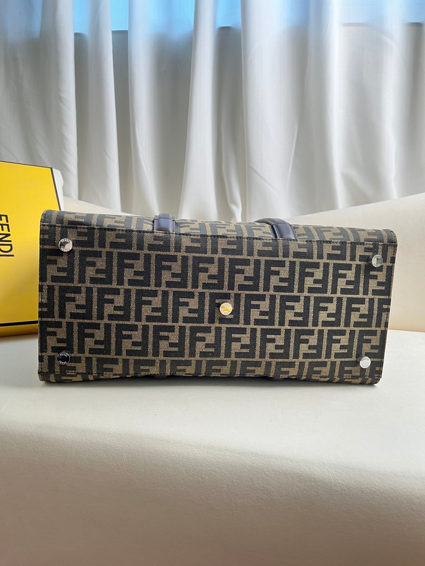 FENDI spacious tote bag in recycled jacquard fabric featuring gray and black FF motif. Featuring fabric-lined interior compartments, interior zip pocket and silver-tone hardware.