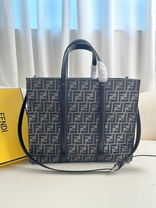 FENDI spacious tote bag in recycled jacquard fabric featuring gray and black FF motif. Featuring fabric-lined interior compartments, interior zip pocket and silver-tone hardware.