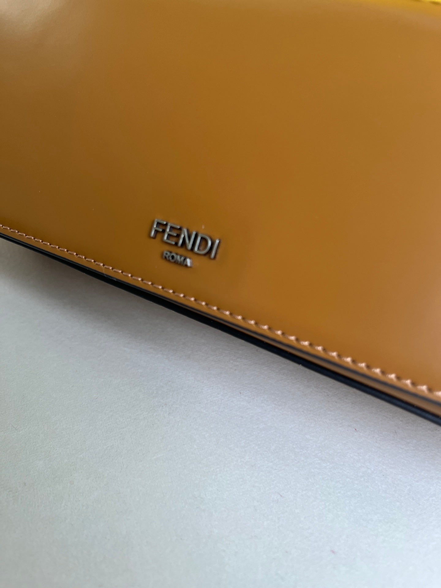 First Sight clutch in smooth calfskin with large F metal hardware and chain