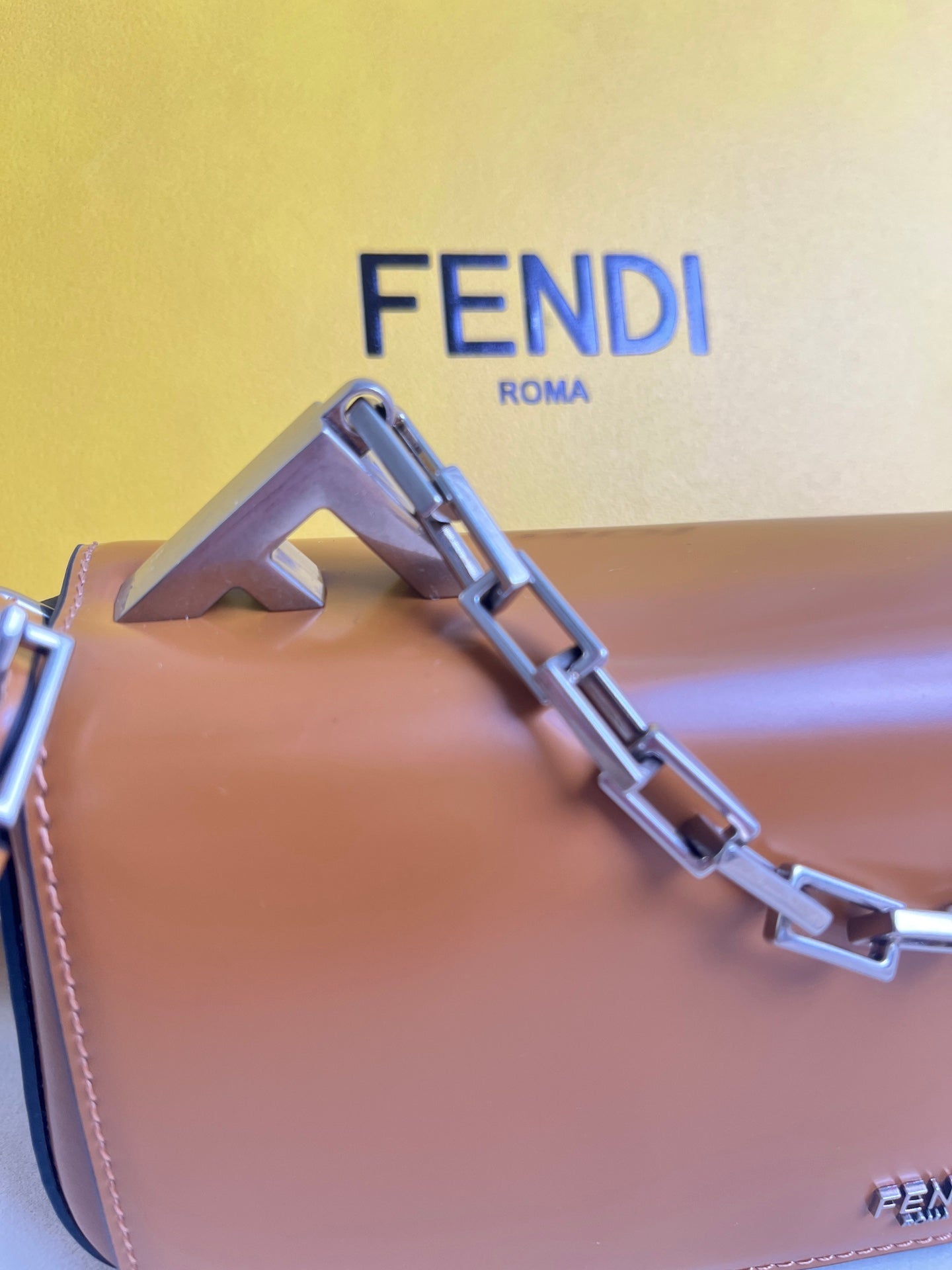 First Sight clutch in smooth calfskin with large F metal hardware and chain