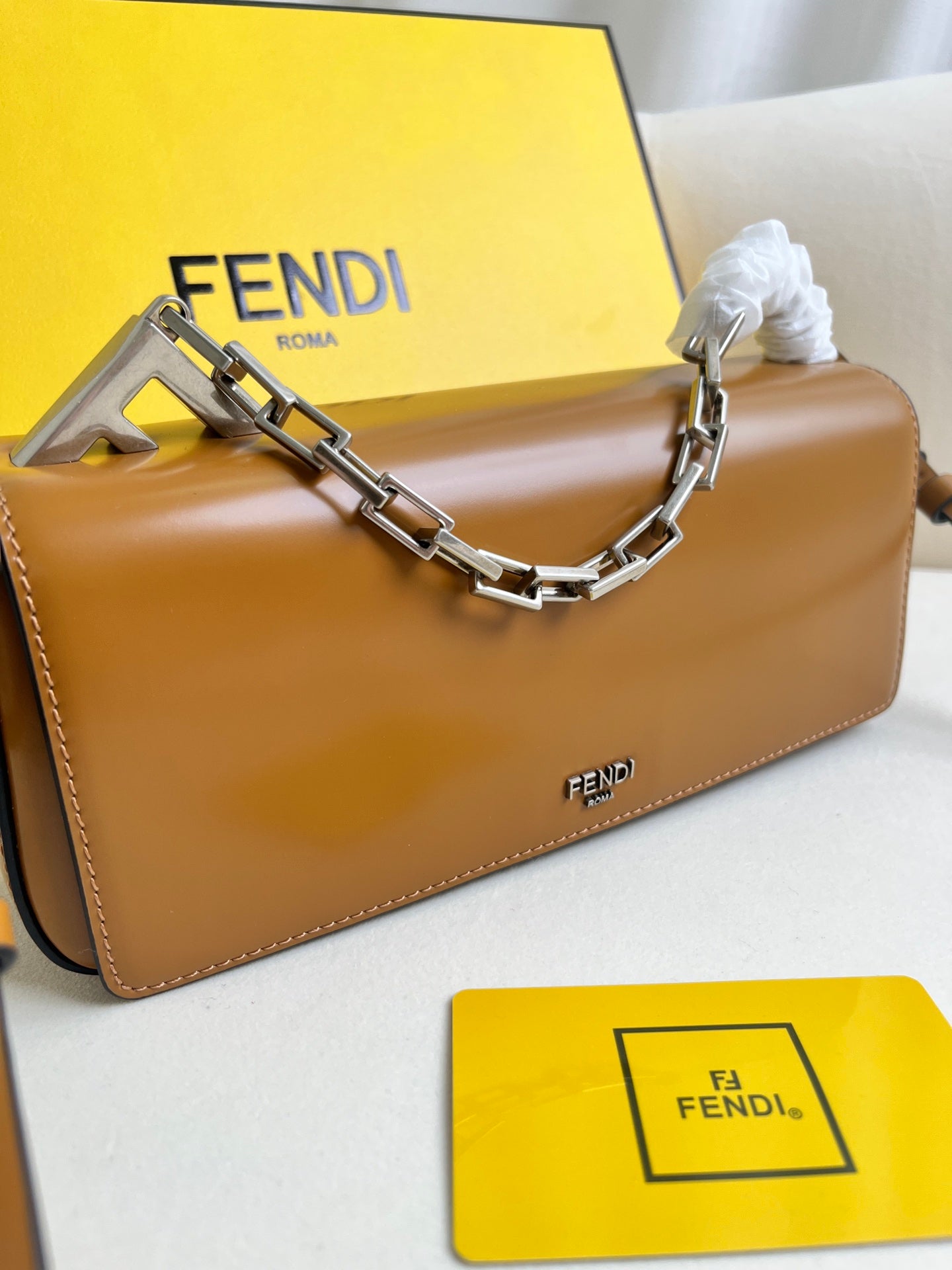 First Sight clutch in smooth calfskin with large F metal hardware and chain